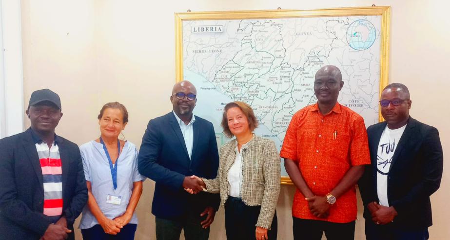 Public Works Minister Roland Layfette Giddings exchanges a handshake with EU Ambassador to Liberia, Nona Deprez.