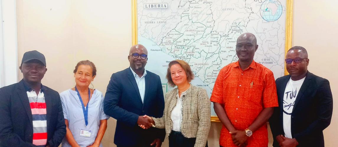 Public Works Minister Roland Layfette Giddings exchanges a handshake with EU Ambassador to Liberia, Nona Deprez.